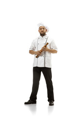 Cooker, chef, baker in uniform isolated on white studio background, gourmet. Young man, restaurant cooker's portrait. Business, foor, professional occupation, emotions concept. Copyspace for ad.