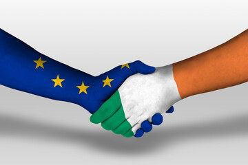 Handshake between ireland and european union flags painted on hands, illustration with clipping...
