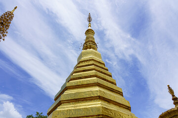 Fototapeta premium The top of the pagoda at Wat Phrathatchohae with blue sky background in Phrae province, Thailand