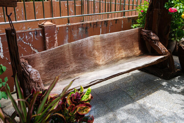 A bench made from tree trunks placed in the garden.