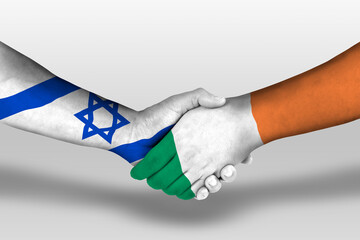 Handshake between ireland and israel flags painted on hands, illustration with clipping path.
