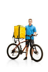 Obraz na płótnie Canvas Deliveryman with bicycle isolated on white studio background. Contacless service during quarantine. Man delivers food during isolation. Safety. Professional occupation. Copyspace for ad.