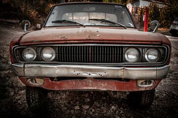 Obraz na płótnie Canvas Lefkada, Greece. Front view of abandoned orange rusty old car.