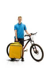 Deliveryman with bicycle isolated on white studio background. Contacless service during quarantine. Man delivers food during isolation. Safety. Professional occupation. Copyspace for ad.