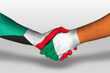 Handshake between ireland and kuwait flags painted on hands, illustration with clipping path.