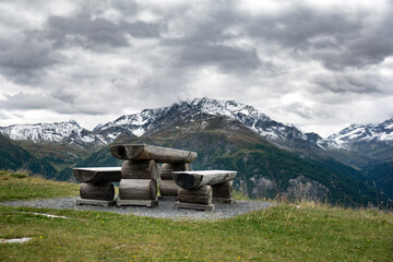 View of a bench with Austrian mountains in background.