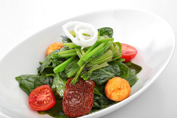 spinach salad white background close up