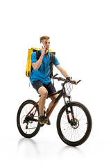 Obraz premium Taking order. Deliveryman with bicycle isolated on white studio background. Contacless service during quarantine. Man delivers food during isolation. Safety. Professional occupation. Copyspace for ad.