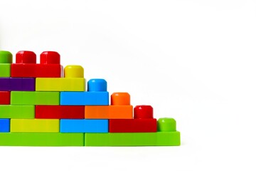 Fototapeta premium Bright multi-colored children's designer on a white background. Interesting educational games for children. Place for text. 