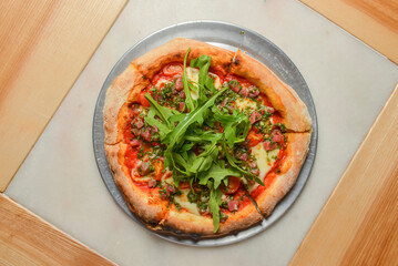 Fresh italian classic original Pepperoni Pizza served on wooden table. Italian cuisine.