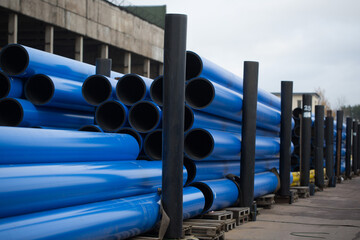 Plastic pipe is stockpiled for storage in the open air