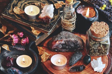 Different types of crystals on wiccan witch altar. Witchcraft themed moody dark photo with various crystals - geode, citrine, quartz cluster, moss agate, kyanite, amethyst, peacock ore, smoky quartz
