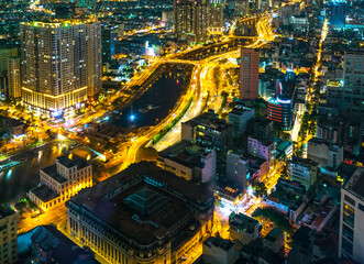 Fototapeta premium Night cityscape from above with lightstreet riverside create shimmering nocturnal beauty city developing dynamically in Ho Chi Minh City, Vietnam