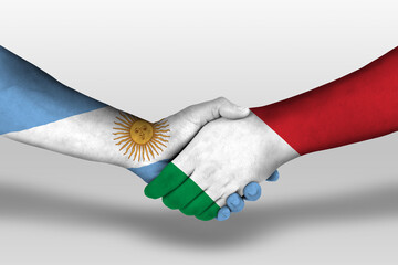 Handshake between italy and argentina flags painted on hands, illustration with clipping path.