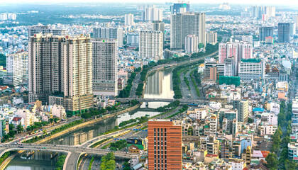 Fototapeta na wymiar High view Saigon central skyline when afternoon down urban areas with tall buildings along river showing development country in Ho Chi Minh City, Vietnam