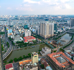 High view Saigon central skyline when afternoon down urban areas with tall buildings along  river showing development country in Ho Chi Minh City, Vietnam
