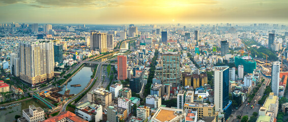 Fototapeta na wymiar High view Saigon skyline when the sun shines down urban areas with tall buildings along the road show development country in Ho Chi Minh, Vietnam