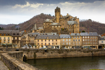 Obraz premium View of medieval castle in picturesque village of Estaing on bank of Lot river, Aveyron, France