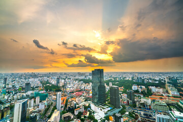  High view Saigon skyline when the sun shines down urban areas with tall buildings along the road show development country in Ho Chi Minh, Vietnam