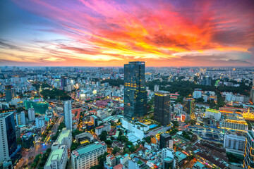  High view Saigon skyline when the sun shines down urban areas with tall buildings along the road show development country in Ho Chi Minh, Vietnam