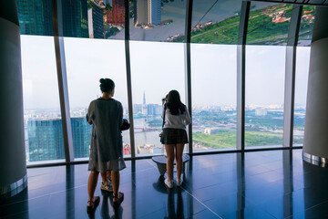 Tourists visit on top of the sky deck panoramic view point in downtown Ho Chi Minh City, Vietnam