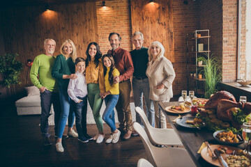 Fototapeta premium Portrait of nice attractive affectionate cheerful family gathering spending vacation festal weekend celebratory occasion November at modern loft industrial brick interior house