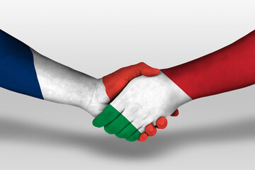 Handshake between italy and france flags painted on hands, illustration with clipping path.