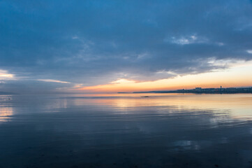 Sunset over Galway in Ireland mirror in the sea, view from the pier. Concepts: tranquil, peace, travel, trip