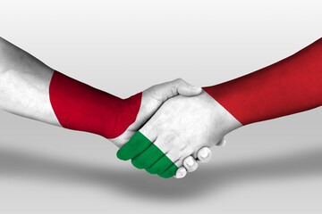Handshake between italy and japan flags painted on hands, illustration with clipping path.