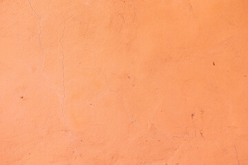 Background and texture of a concrete wall painted with salmon paint