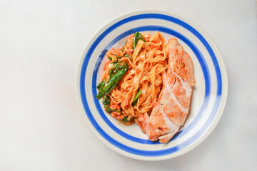 Plate of penne pasta with cheese and meat. Healthy and delicious dinner.