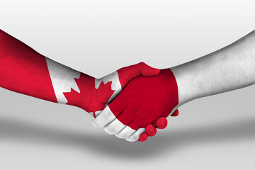 Handshake between japan and canada flags painted on hands, illustration with clipping path.