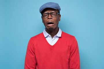 African american young man in glasses crying