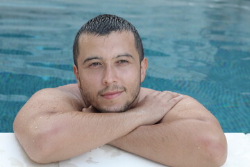 Ethnic man relaxing in swimming pool 