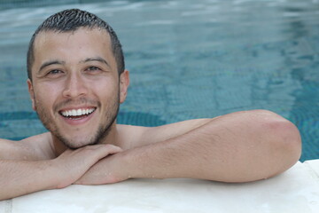 Ethnic man relaxing in swimming pool 