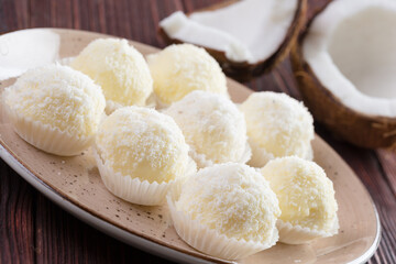 White chocolate candies with coconut topping close up