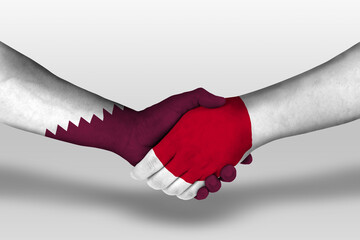 Handshake between japan and qatar flags painted on hands, illustration with clipping path.