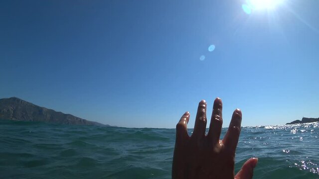 Iztuzu Beach, Dalyan, Turkey - 17th of August 2020: 4K Hand waving for help as seen by the drowing person
