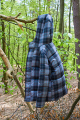jacket hanging on a tree,on a branch hangs a winter children's jacket