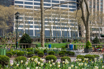 Tables and chairs and Skyscrapers viewed from Bryant Park in Midtown Manhattan, New York, NYC, the USA. 