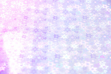 Blurred pink trendy backdrop with stars. Bright holographic foil background. Colorful background. Flat lay