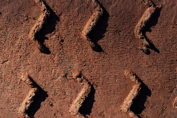 on the muddy road
automobile tire track