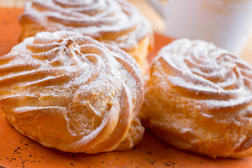 Small french cookies profitroles with sugar powder