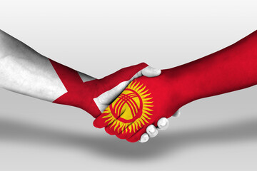 Handshake between kyrgyzstan and england flags painted on hands, illustration with clipping path.