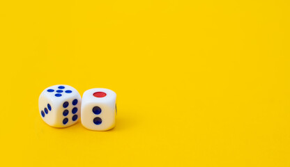 Two game cubes are laid out on a yellow background: entertainment, games at home for the whole family, the concept of Board games. Table game, text space