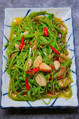 Sliced morning glory sauteed with oyster sauce, chilli and garlic