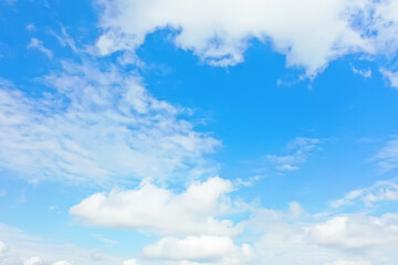 white clouds on blue sky background, abstract seasonal wallpaper, sunny day atmosphere