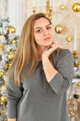 Portrait of beautiful young woman posing in room