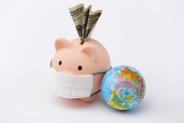 Piggy bank in medical mask with banknote, globe on white background. Economic disease. Financial...
