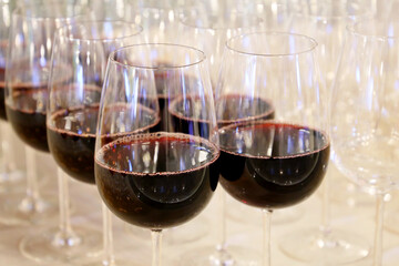 Glasses with red wine in a restaurant. Concept of celebration, official reception, romantic party